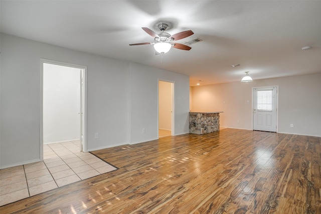 spare room with light hardwood / wood-style floors and ceiling fan