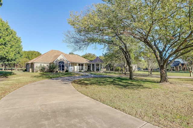 ranch-style home with a front lawn