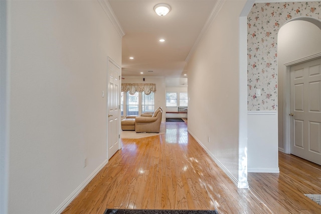 hall with wood-type flooring and crown molding