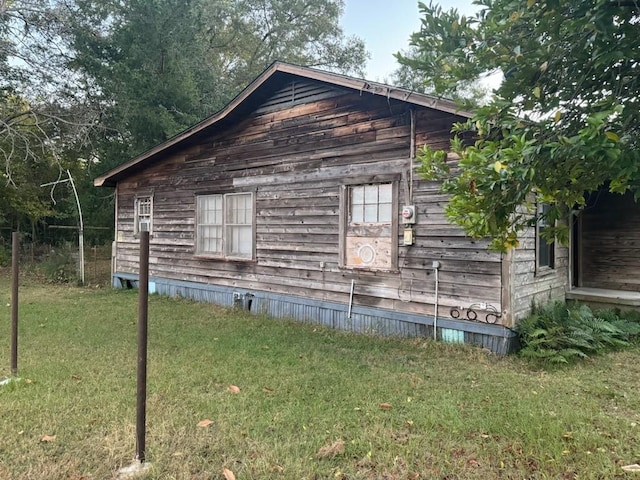 view of side of property with a yard