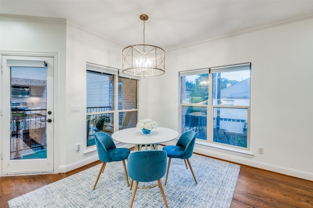 dining space with dark hardwood / wood-style floors and ornamental molding