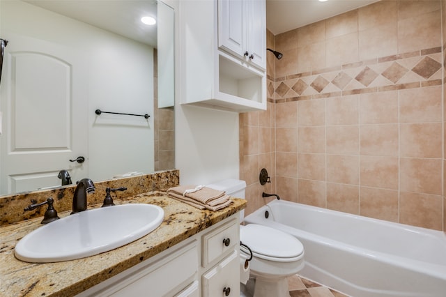 full bathroom featuring tiled shower / bath, tile patterned floors, toilet, and vanity