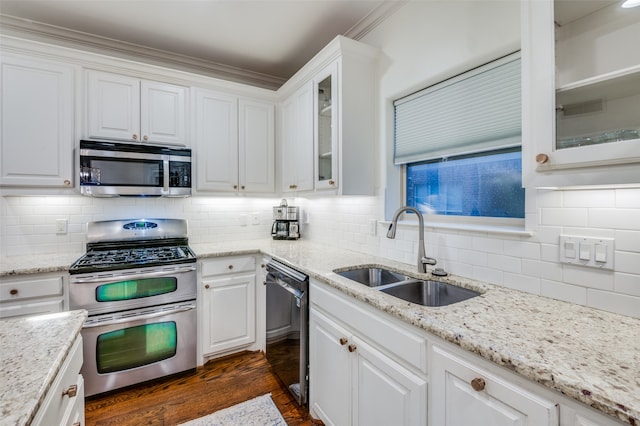 kitchen featuring white cabinetry, appliances with stainless steel finishes, sink, and backsplash