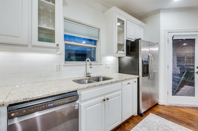 kitchen with stainless steel appliances, white cabinets, and sink