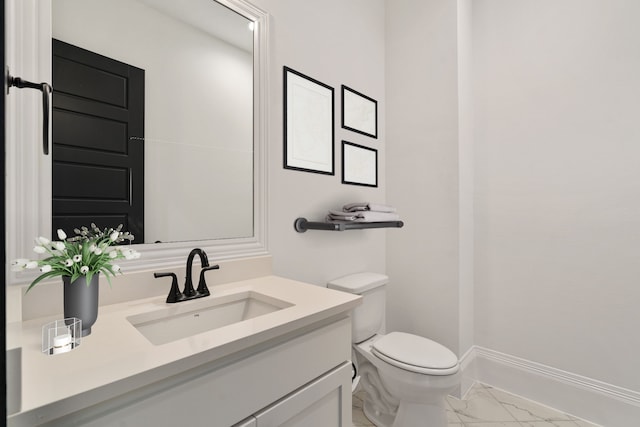 bathroom featuring toilet and vanity