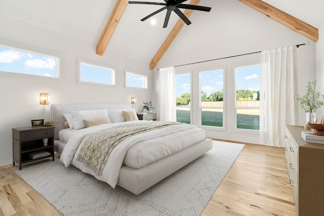 bedroom featuring ceiling fan, multiple windows, light wood-type flooring, and high vaulted ceiling