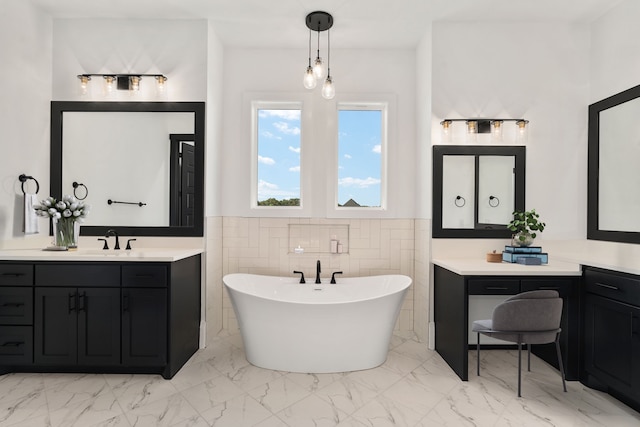 bathroom with tile walls, a bathtub, and vanity