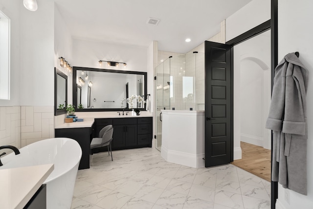 bathroom featuring hardwood / wood-style floors, vanity, and separate shower and tub