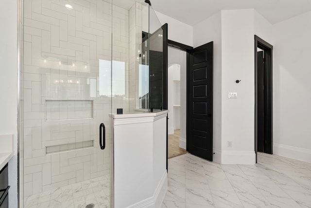 bathroom featuring a shower with door