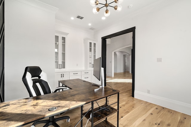 home office with an inviting chandelier, light hardwood / wood-style flooring, and crown molding