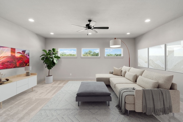 living room featuring light colored carpet and ceiling fan