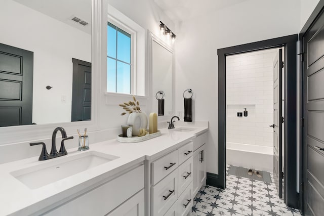 bathroom with a washtub and vanity