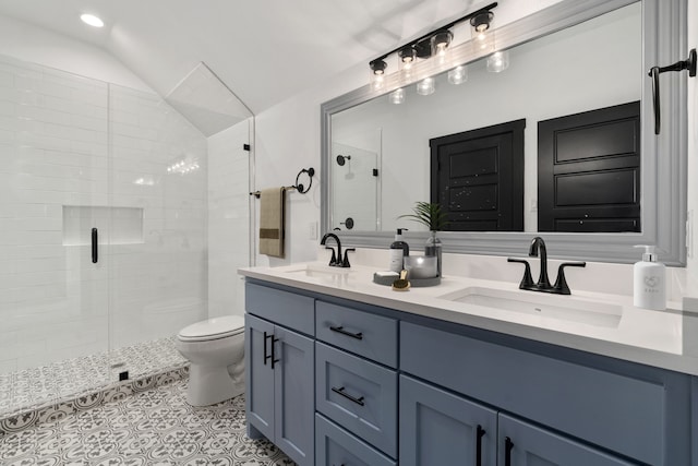 bathroom featuring an enclosed shower, lofted ceiling, toilet, and vanity