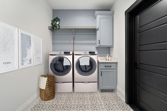 washroom with cabinets, light tile patterned floors, and independent washer and dryer