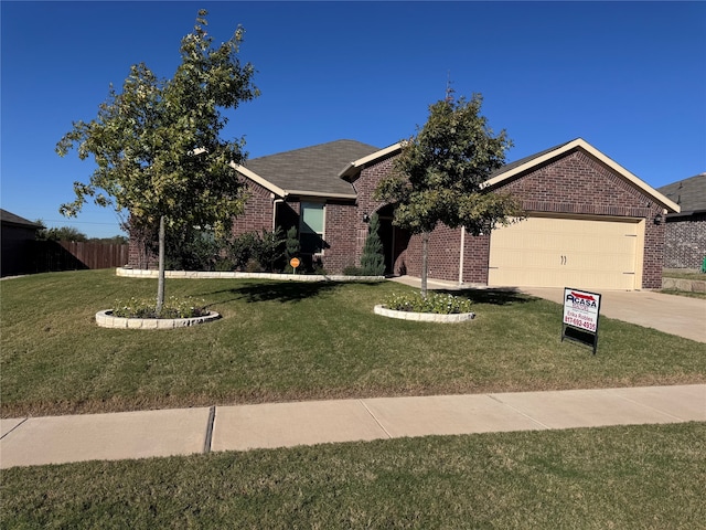 view of front of home featuring a front yard and a garage