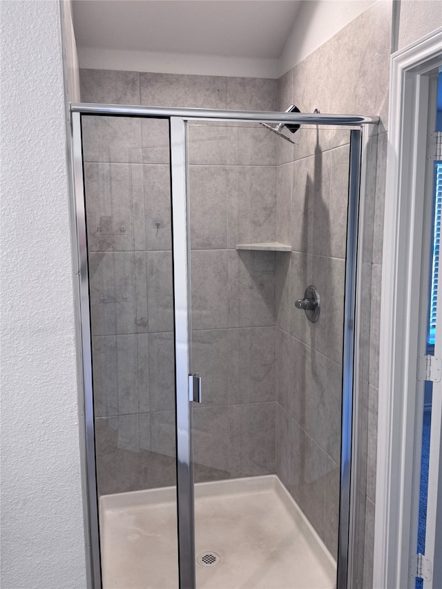 bathroom featuring vaulted ceiling and an enclosed shower