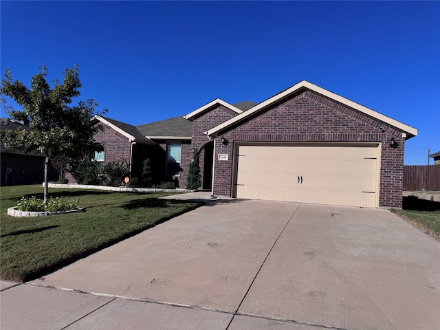 ranch-style home with a garage and a front lawn