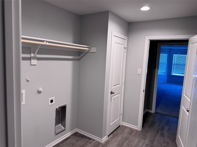 clothes washing area with electric dryer hookup and dark wood-type flooring