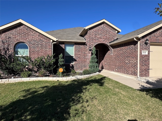 view of front of home featuring a garage and a front lawn