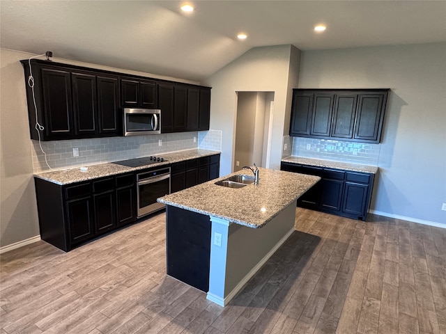 kitchen featuring backsplash, light hardwood / wood-style flooring, and stainless steel appliances