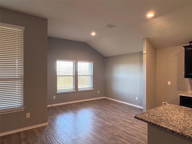 interior space with lofted ceiling and dark hardwood / wood-style flooring