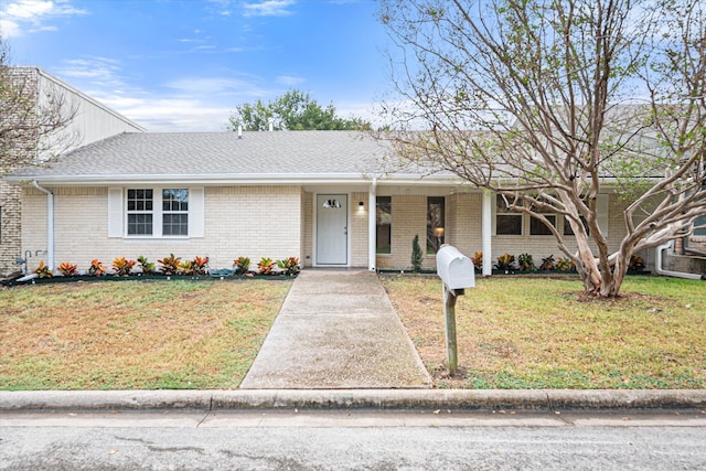 ranch-style home with a front lawn