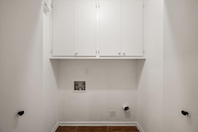 laundry area featuring cabinets, dark tile patterned flooring, electric dryer hookup, and hookup for a washing machine