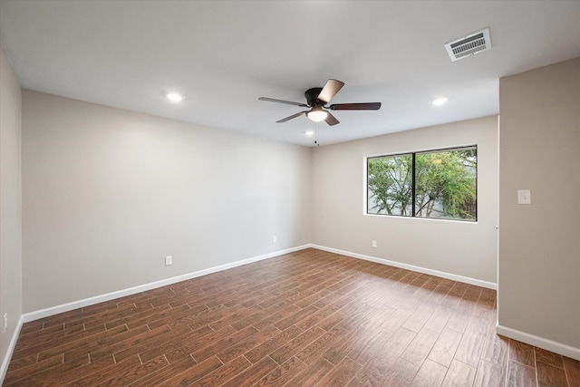 empty room featuring dark hardwood / wood-style flooring and ceiling fan