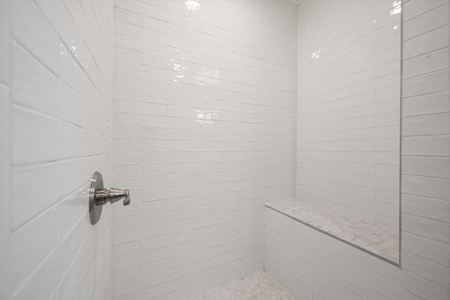 bathroom with a tile shower