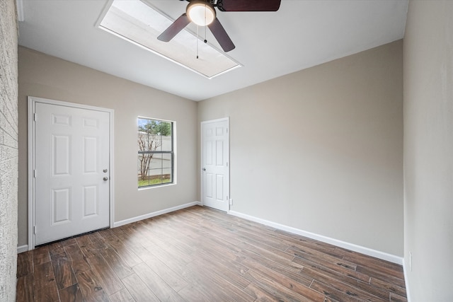 empty room featuring dark hardwood / wood-style flooring and ceiling fan