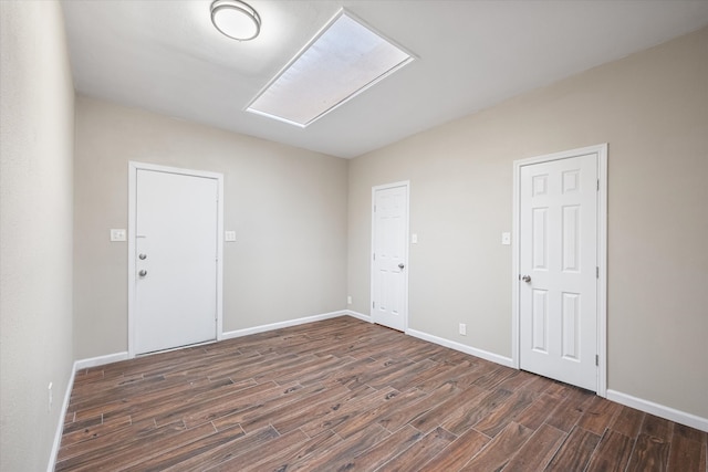 spare room featuring dark hardwood / wood-style flooring