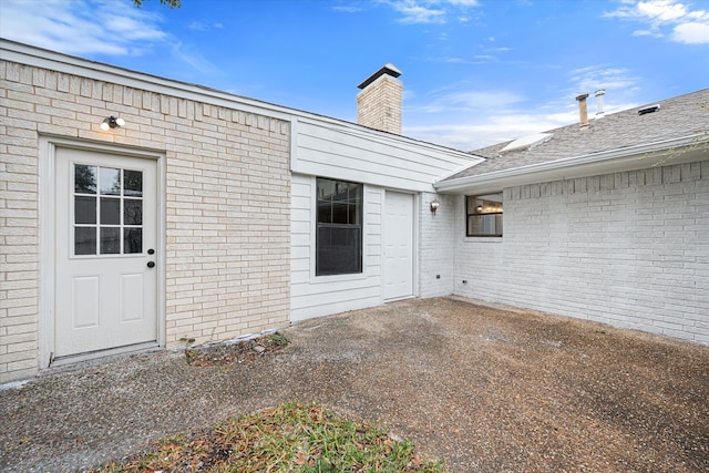 entrance to property featuring a patio