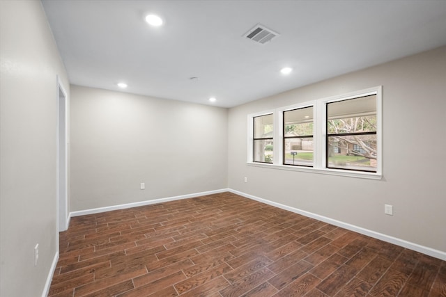 empty room with dark hardwood / wood-style floors