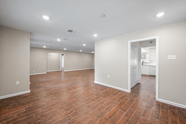 spare room featuring dark wood-type flooring and sink