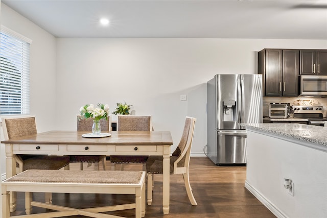 dining space with dark hardwood / wood-style floors