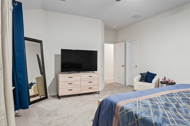 bedroom with lofted ceiling and light colored carpet