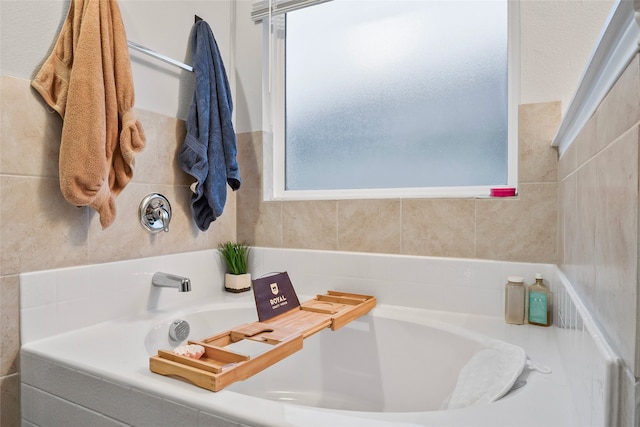 bathroom featuring a relaxing tiled tub