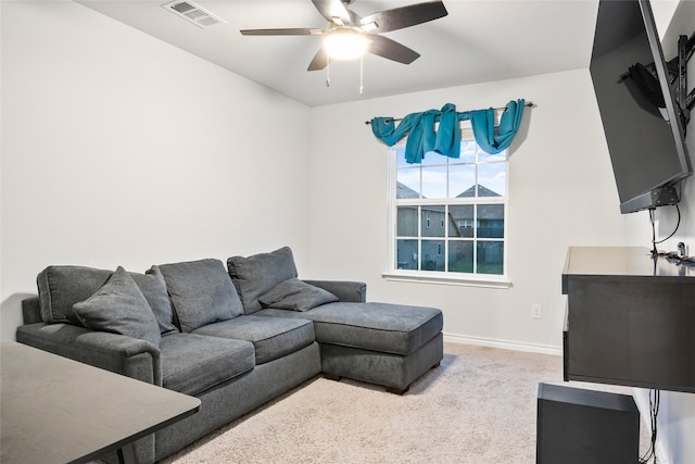 carpeted living room with ceiling fan