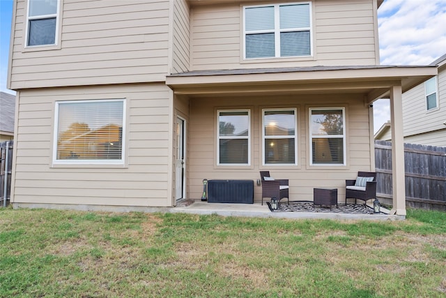 rear view of house with a patio, a yard, and an outdoor hangout area