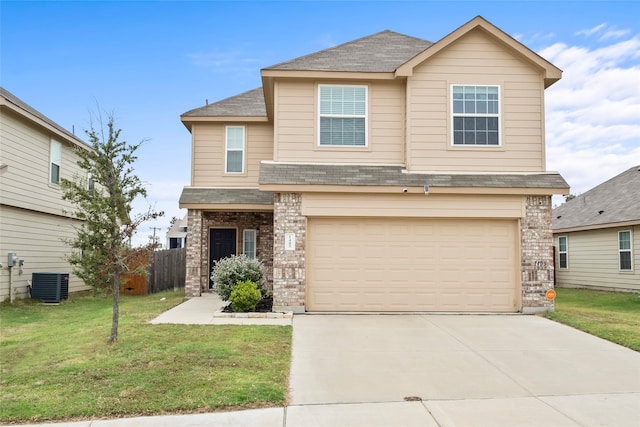 view of front of house featuring a garage, a front yard, and central air condition unit