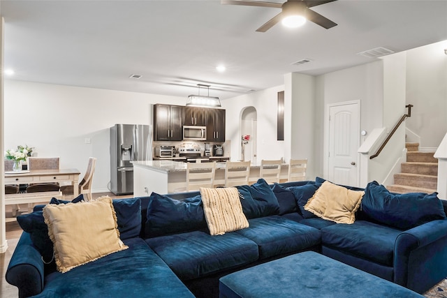 living room with hardwood / wood-style flooring and ceiling fan