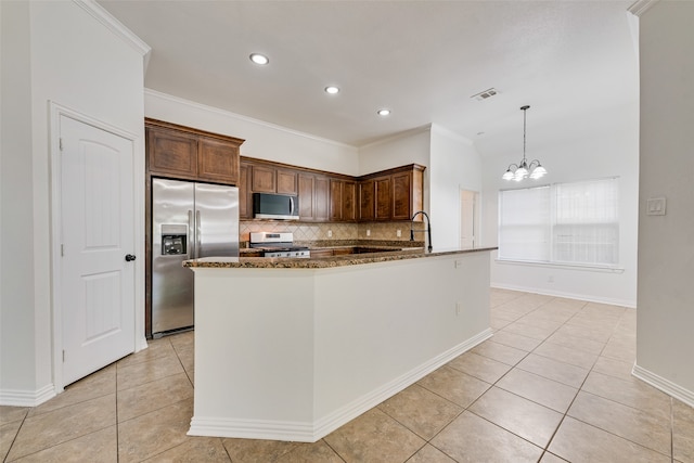 kitchen featuring stone countertops, decorative light fixtures, decorative backsplash, light tile patterned floors, and appliances with stainless steel finishes