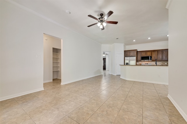 unfurnished living room with ceiling fan, crown molding, and light tile patterned flooring