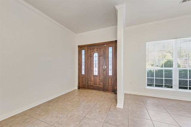 foyer with light tile patterned flooring, ornamental molding, and decorative columns