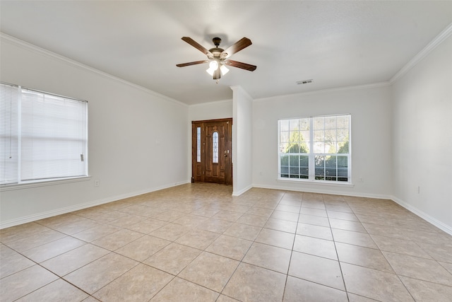 tiled entrance foyer with ceiling fan and ornamental molding