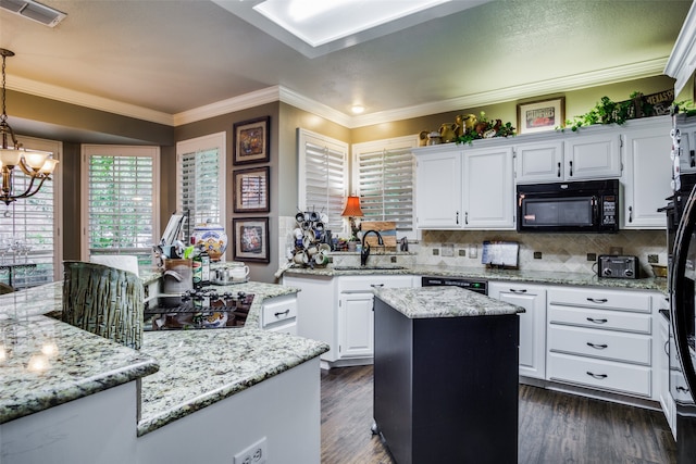 kitchen with dark hardwood / wood-style flooring, black appliances, sink, a kitchen island, and white cabinetry