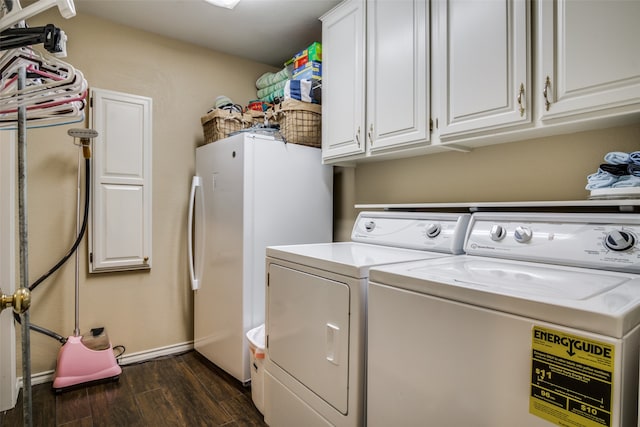 laundry area with dark wood-type flooring, cabinets, and separate washer and dryer