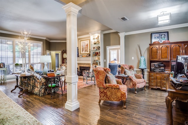 living room with dark hardwood / wood-style floors, a healthy amount of sunlight, crown molding, and decorative columns