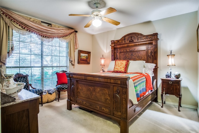 bedroom featuring light carpet and ceiling fan