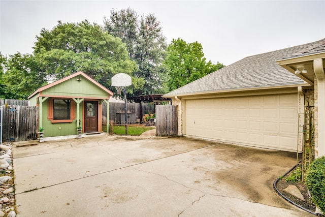 view of front facade featuring a garage and an outdoor structure